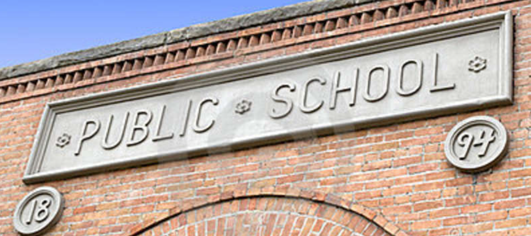 Public Schools Don’t Need to Run the EFTC Carved PUBLIC SCHOOL sign on a historic brick school building, illustrating why public schools can partner with a Scholarship Granting Organization instead of becoming one